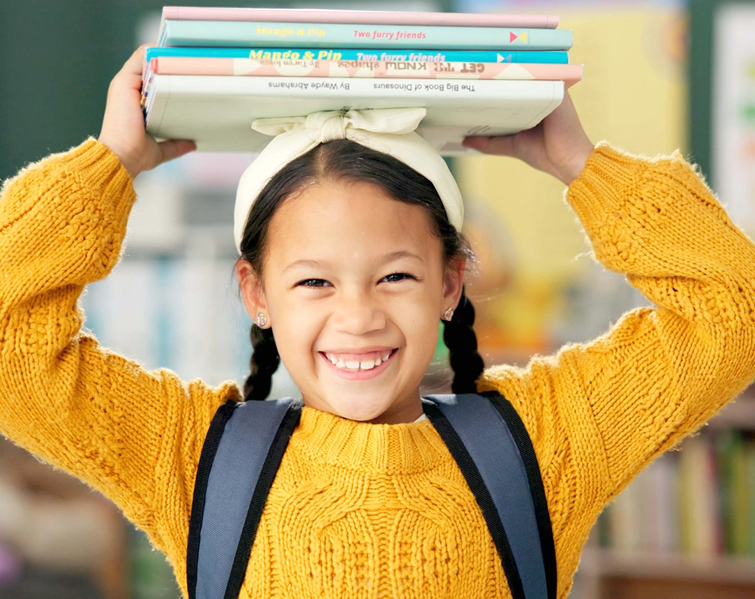 Student with books smilling