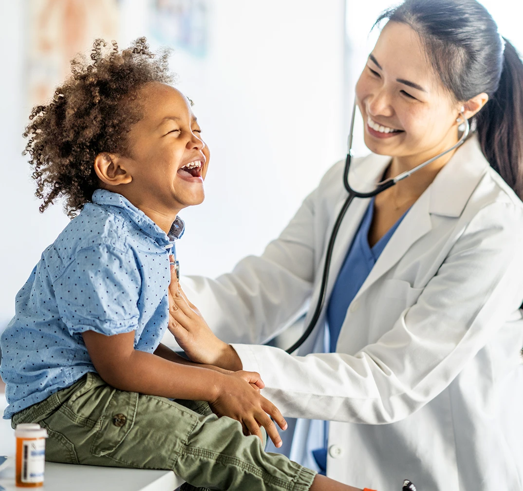 Nurse and child laughing