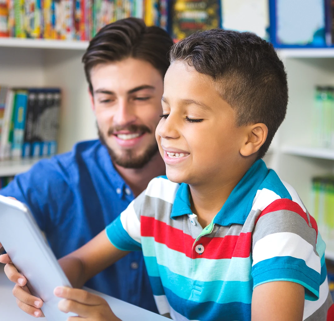Teacher and school kid using digital tablet
