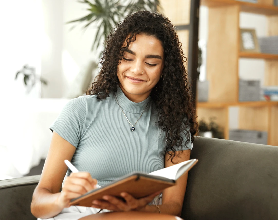 Woman writing notes in notebook