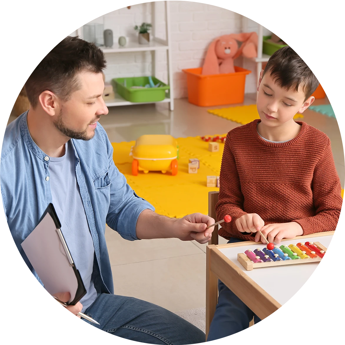 psychologist working with little boy in office